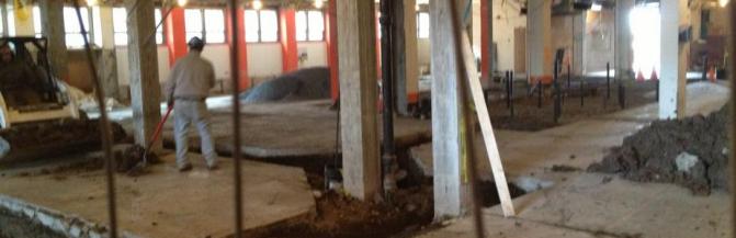 Construction photo of Houston Gym showing the existing floor slab cut with trenches