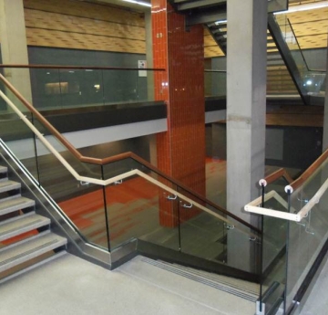 View of open two story with glass railings and skylight at roof